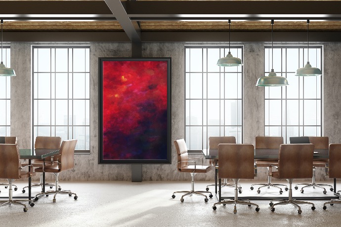 picture of an office space with two conference tables and a colorful acrylic painting on the wall 